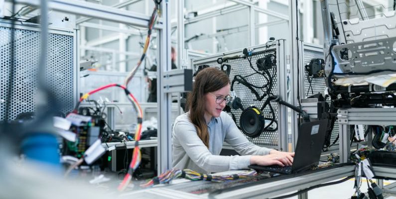 Manufacturing - woman in white long sleeve shirt using black laptop computer