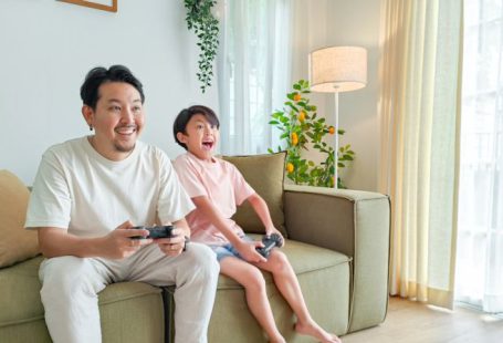 Gaming - a person and a child sitting on a couch