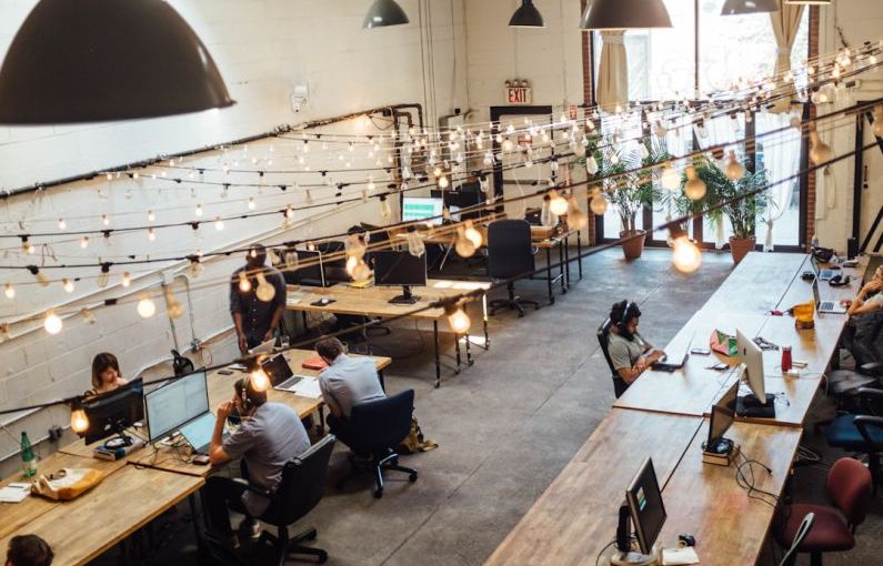 Coworking Spaces - people sitting in front of computer monitors