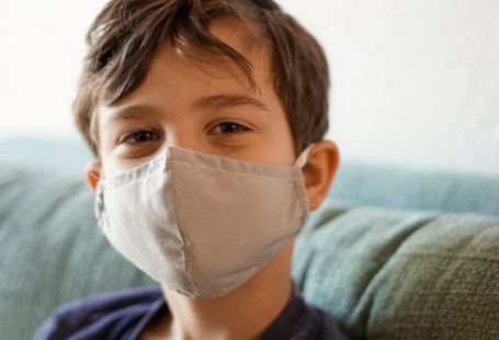 Safety Compliance - boy in blue crew neck shirt with white face mask