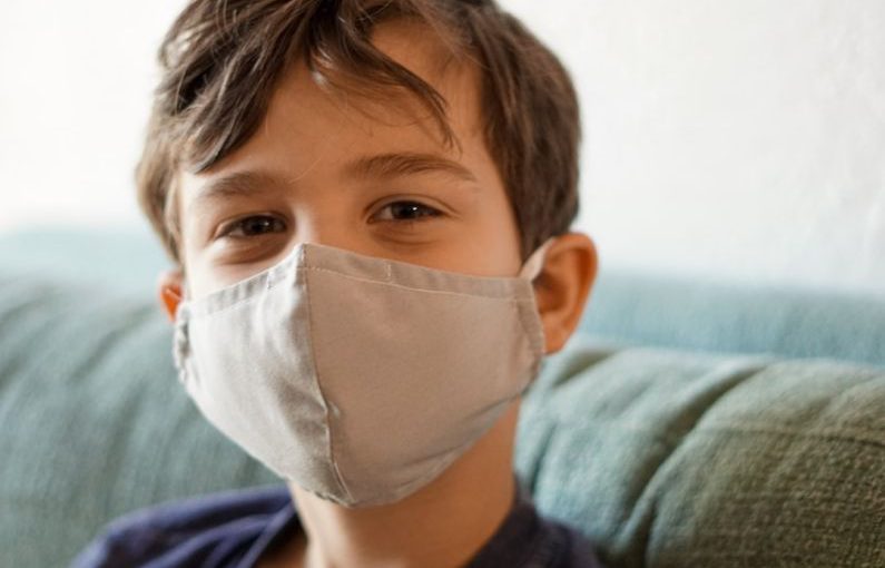 Safety Compliance - boy in blue crew neck shirt with white face mask