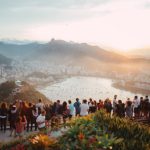 Tourism - group of people standing facing lake view