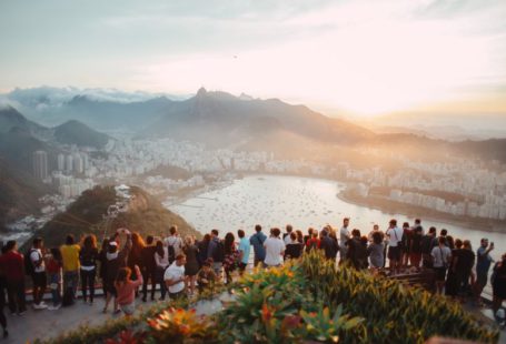 Tourism - group of people standing facing lake view