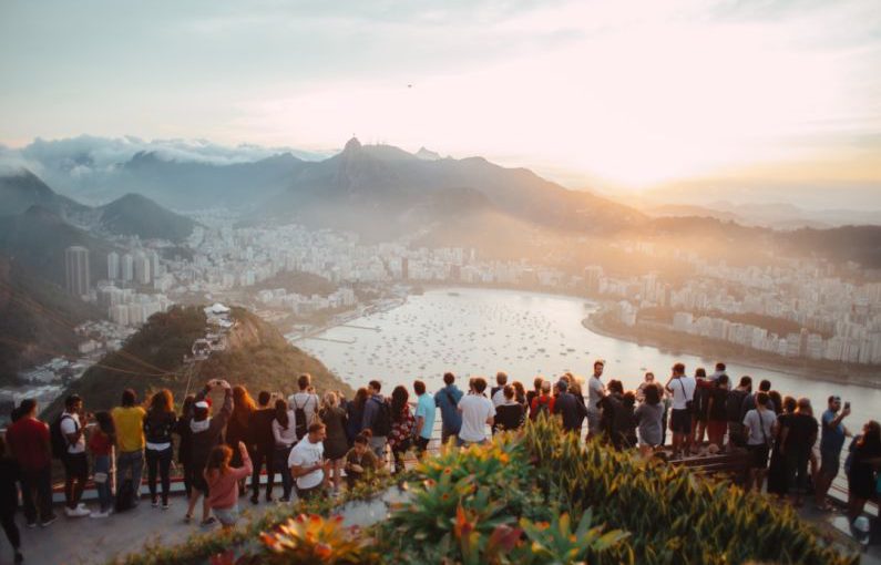 Tourism - group of people standing facing lake view