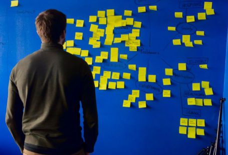 Startups - man in gray long sleeve shirt standing in front of blue and yellow puzzle mat