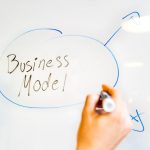 Business Model - person writing on white paper