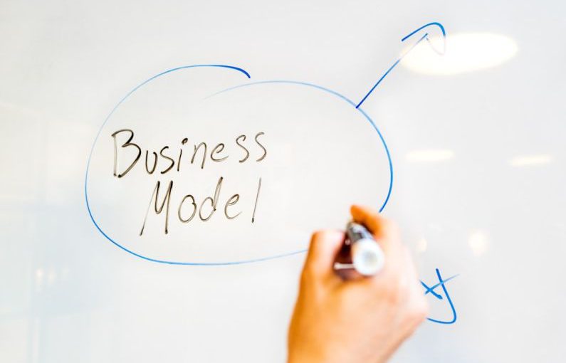 Business Model - person writing on white paper