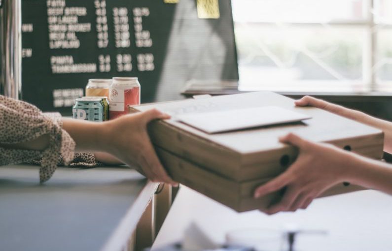 Local Business - person holding white printer paper