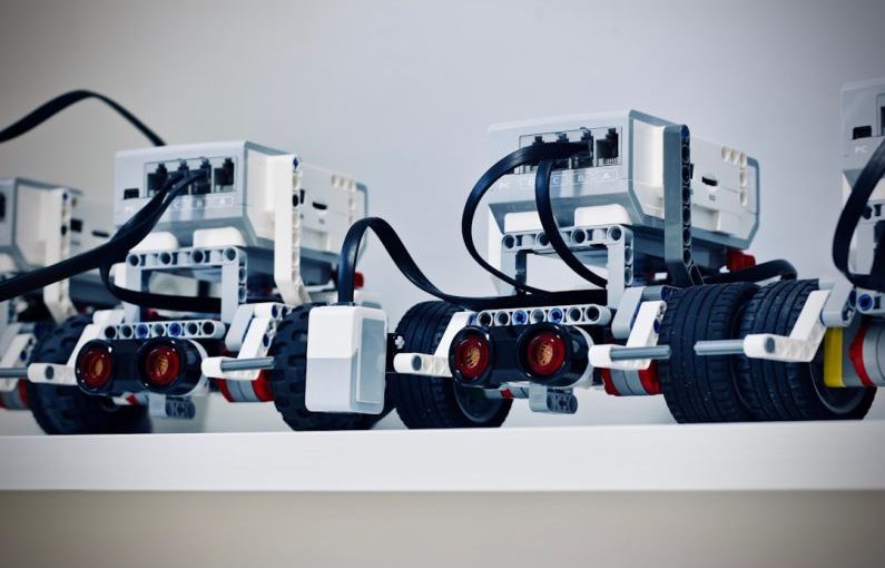 Robotics - two white and black electronic device with wheels