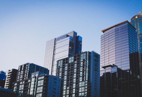 Real Estate - white and blue glass walled high rise building