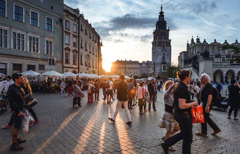 Tourism - people walking on street near concrete buildings