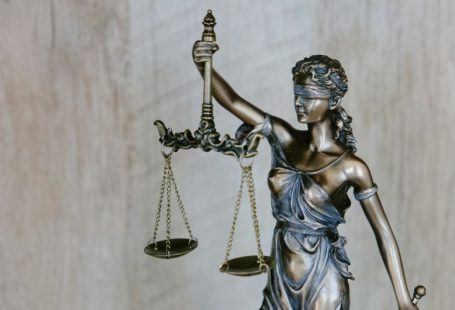 Legal - woman holding sword statue during daytime