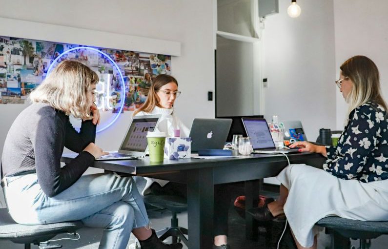 Startups - 3 women sitting on chair in front of table with laptop computers
