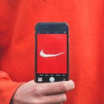 Brand - person holding iPhone taking picture on Nike label