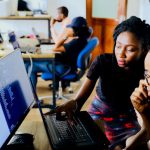 Tech Startup - woman and man sitting in front of monitor