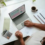 Business - a person sitting at a table with a laptop
