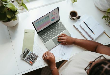 Business - a person sitting at a table with a laptop