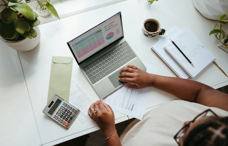Business - a person sitting at a table with a laptop