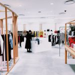 Retail - woman standing inside clothing area