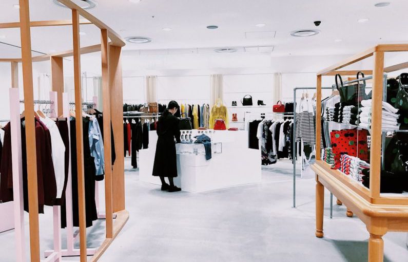 Retail - woman standing inside clothing area