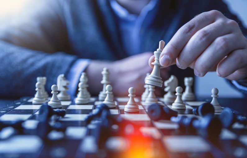 Digital Business - depth of field photography of man playing chess