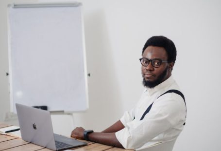 Startup - a man sitting at a table with a laptop in front of him