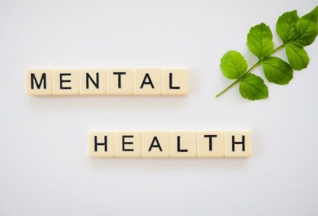 Mental Health - the word mental health spelled with scrabbles next to a green leaf