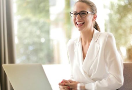 Edtech Startup - Laughing businesswoman working in office with laptop