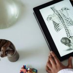 Material Science - Unrecognizable African American scientist studying anatomy with tablet