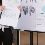 Venture Capital - Woman in Gray Coat Holding White Printer Paper