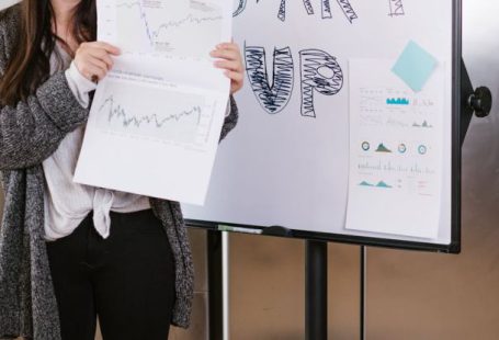 Venture Capital - Woman in Gray Coat Holding White Printer Paper