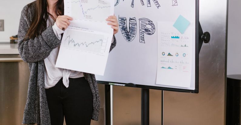 Venture Capital - Woman in Gray Coat Holding White Printer Paper
