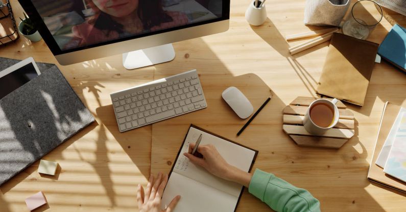 Online Training - Person Writing on Notebook