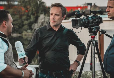 Media Coverage - Man Holding Microphone While Talking to Another Man